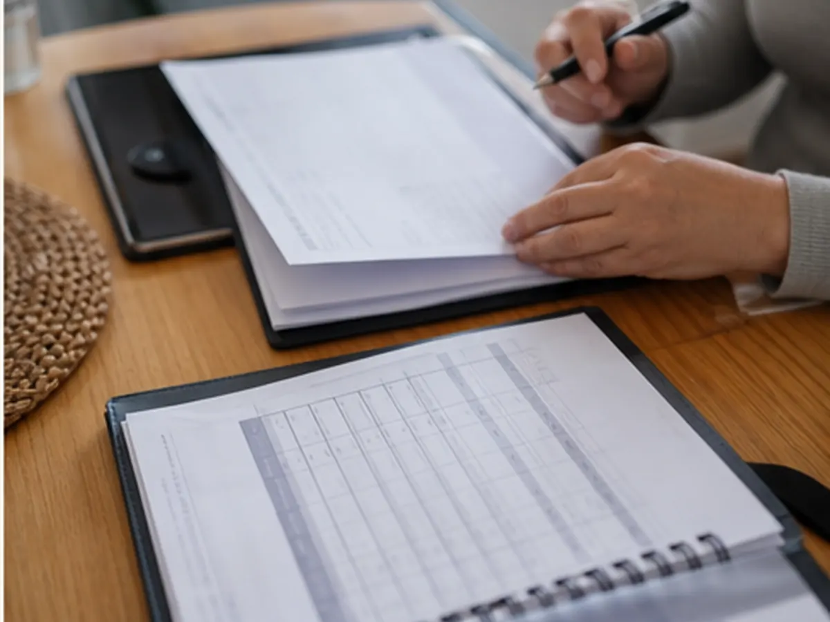 Service schedule and claim paperwork arranged on a household table