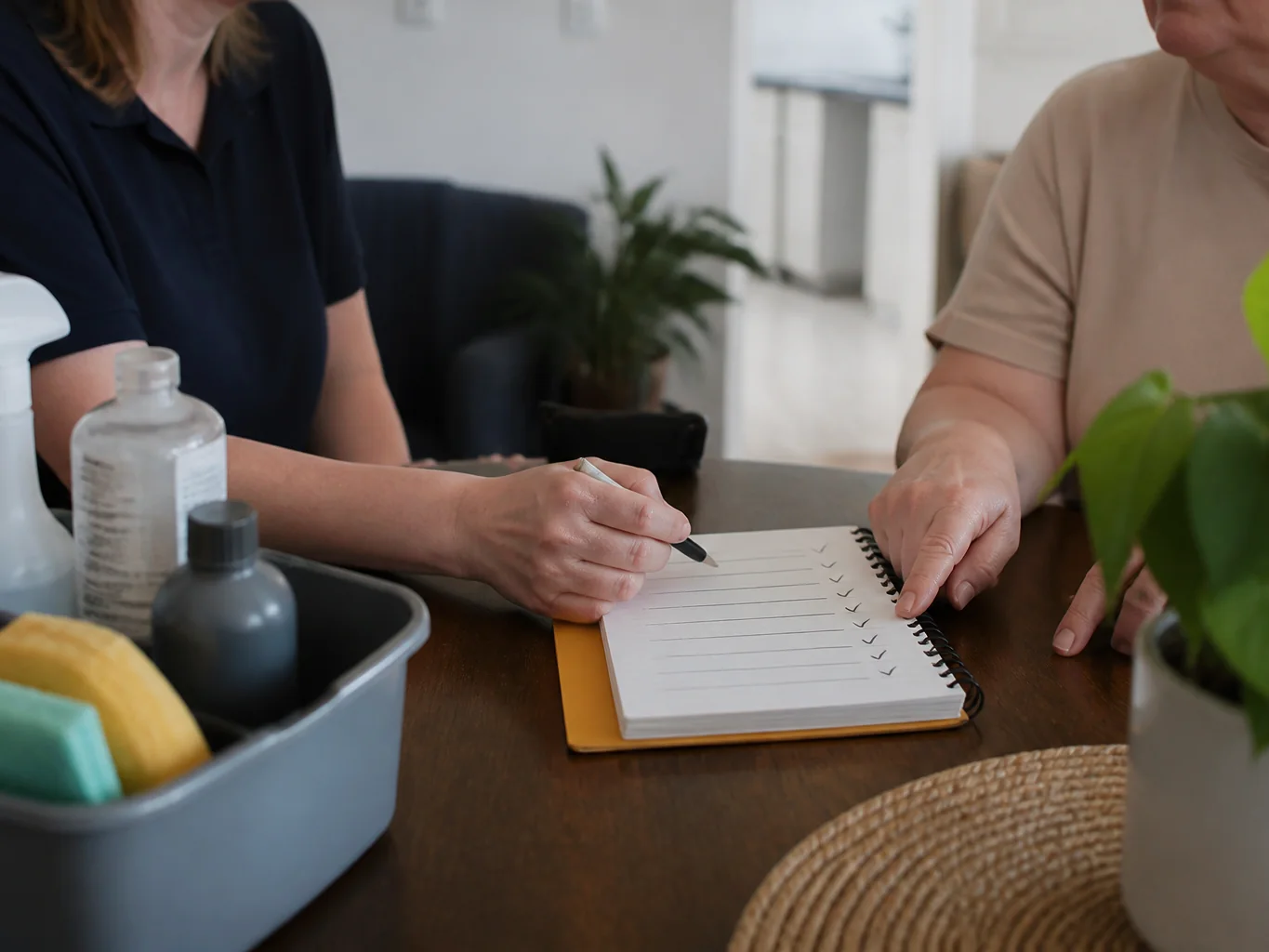 Cleaner and resident agreeing on household cleaning priorities at a table